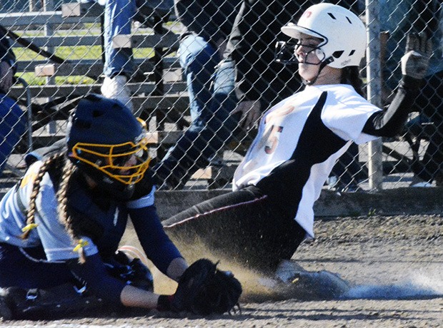 A Marysville-Pilchuck softball player slides home.