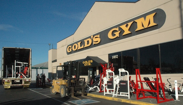 Moving crews remove the equipment from the Gold's Gym located at 1052 State Ave. in Marysville.