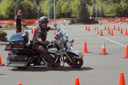 Marysville Police Officer Pat McShane angles his way around traffic cones May 15 to simulate avoiding accidents while on patrol.