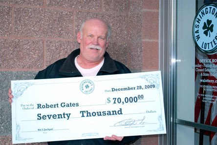 Arlington resident Robert Gates proudly displays his check for $70