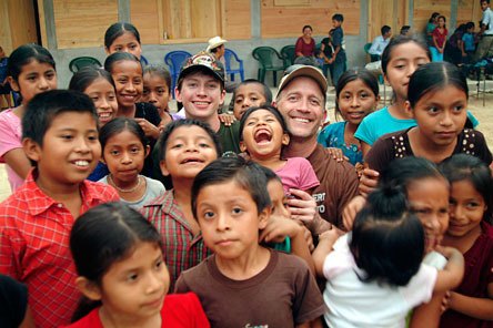 Marysville’s Michael and Kelly Peterson are surrounded by the children who will attend the three-room school they helped build in the Guatemalan village of Nuevo Cuchumatan.