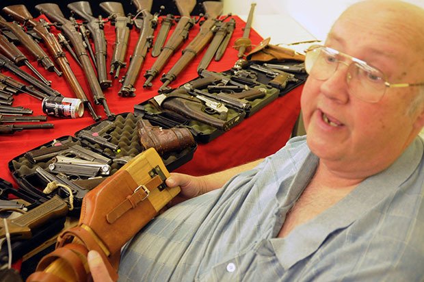 Show promoter Doug Kerley of Big Top Promotions shows off some historic weaponry at Marysville's gun show July 11.