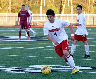 M-P sophomore Cesar Galvan receives a pass from senior Sean Wagner during an April 13 home game against the Cascade Bruins. The Tomahawks defeated the Bruins 3-1.
