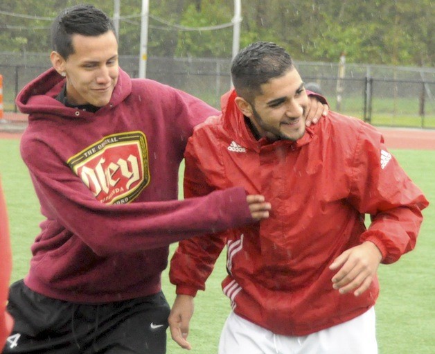 Cristian Correa-Avila pals around with teammate Sebastian Navarro during a recent practice.