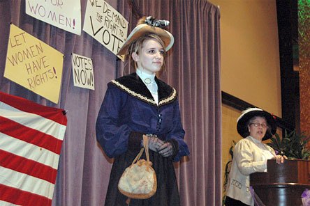 Model Akaylah Cooper shows off her early 1900s-era clothing while Lynn Gough