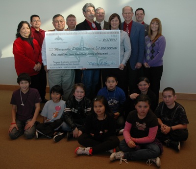 Tulalip Tribal Board members hand over an oversized check for $1.26 million to Marysville School Board members on Feb. 10