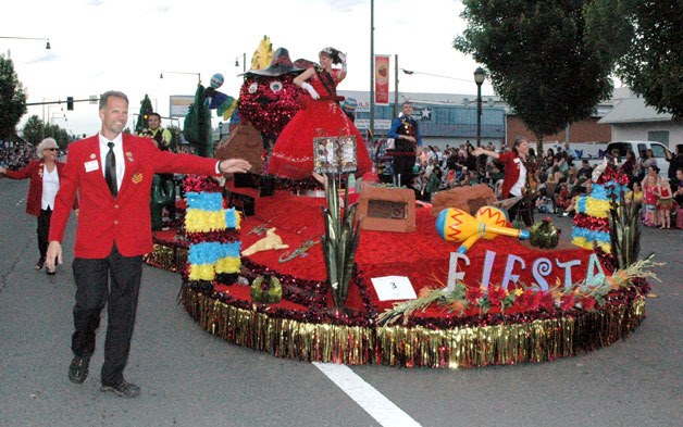 The Strawberry Festival Royalty proceed down State Avenue on their float during the June 15 Grand Parade.