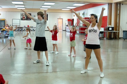 Tomahawk cheerleaders Brandon Durland and Kristana Rendon lead the youngest group of campers