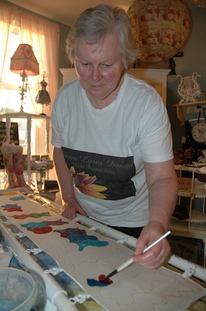 Karen Lyons paints a silk scarf at The Vintage Violet during Marysville's first 'Art Walk' on Sept. 13.