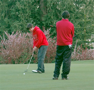 While Highland Christian’s Craig Crawford holds the pin