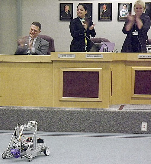 Marysville School Board members Chris Nation and Mariana Maksimos clap for the robotics demonstration