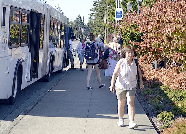 Riders pile out of a Community Transit bus at the end of a work day at the Cedar and Grove park and ride lot. CT would like to pass a levy in November so it can expand with more and more frequent routes.