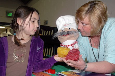 Marysville’s Brianna Edwards gets to feel hands-on squishy models of how a pound of muscle and a pound of fat feel