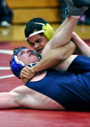 Marysville-Pilchuck’s Killian Page pins Arlington’s Jesse Driscoll during a match at Marysville-Pilchuck High School on Thursday