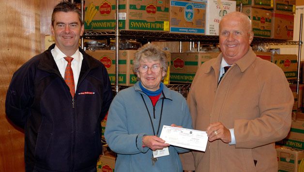 Marysville Community Food Bank Volunteer Coordinator JoAnn Sewell receives a check for $2