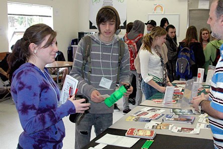 Marysville Mountain View students Sonja Olson and Alex Cullinane speak with a vendor during the school’s career fair on Friday