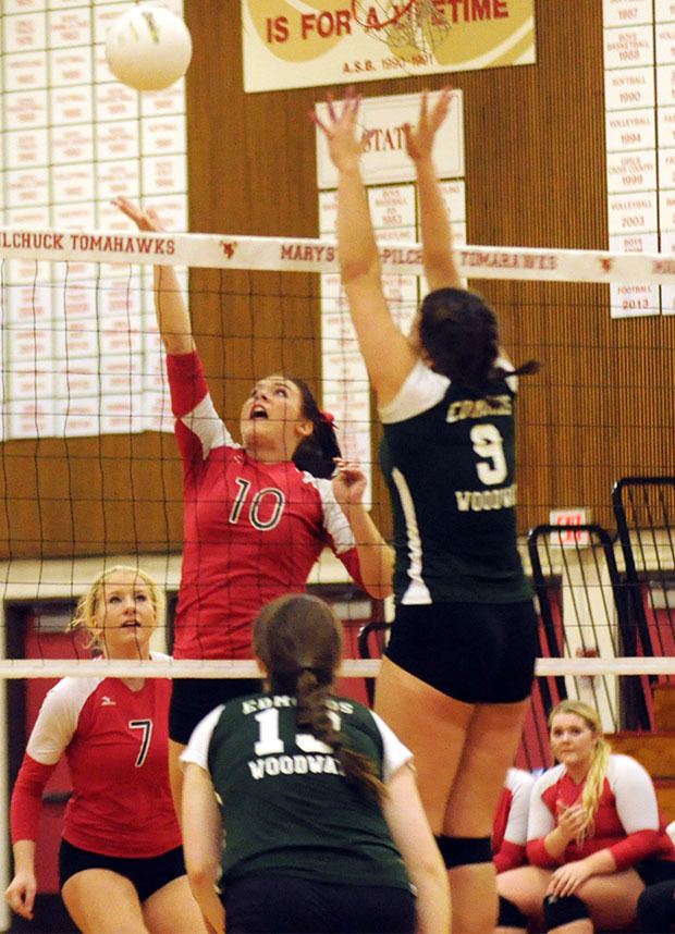 Marysville-Pilchuck sophomore outside hitter Alexis Bundy attempts spike through Edmonds Woodway defenders.