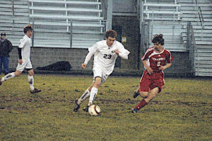Sophomore midfielder Collin Carlson tries to steal the ball away from Arlington’s Zach Fulwiller.