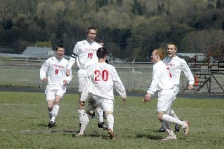 An ecstatic M-P team celebrates Ryan Wilson’s second goal at midfield. From left