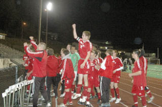 Senior defender Brian Nobach leaps for joy as the Tommies greet their fans.