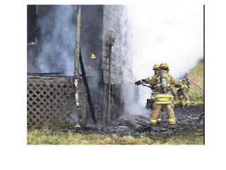 Firefighters try to douse the flames that damaged this home on 74th Drive NE.