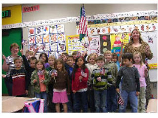 Cougar Creek Elementary School teacher Holly Burtt and her first-grade class presented 14 hand-sewn “friendship paw” quilts to military families of students from their school at the end of the school year. Stephanie Davis
