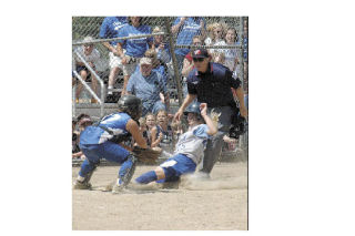 Slugger Hailey Malakowski slides in under the Sedro-Woolley catcher’s glove
