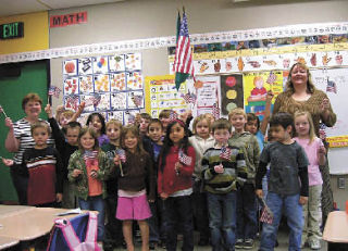 Cougar Creek Elementary School teacher Holly Burtt and her first-grade class presented 14 hand-sewn “friendship paw” quilts to military families of students from their school at the end of the school year. Stephanie Davis