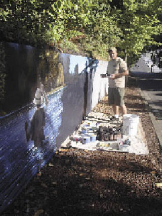 Harry Engstrom paints more on the “Stream Life of the Stillaguamish River” on the retaining wall on Olympic Hill at the south end of North Olympic Avenue in downtown Arlington. The new mural is one of four new works of public art in Arlington as a result of the 2007 Fall into Art Auction.