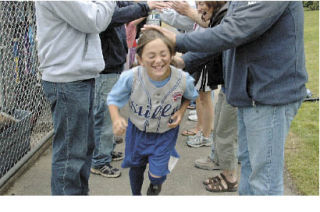 Shyne McKay beams as the Stilly Valley parents and fans created a cheer tunnel as the girls left the dugout after their win over Lake Spokane. At Everest Park Stilly Valley 3 0 5 0 1 4 13 Lk. Spokane 0 0 0 0 0 0 0