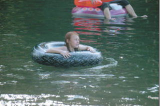 Eight-year-old Alexis Brooks floats on the gentle waves of the waters at Twin Lakes.