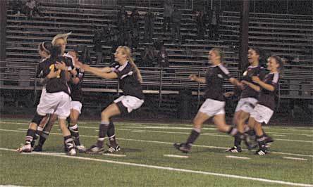 Lakewood teammates rush junior forward Alisha Stott