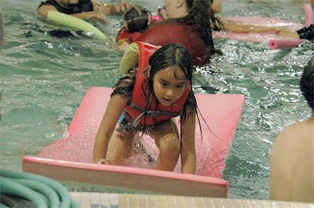 Arefli Marmolejo makes good use of the water toys in the Marysville-Pilchuck pool during the third and final free swim for spring.