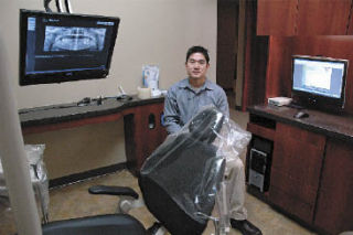 Dr. Whan Mike Cho uses technology such as ceiling-mounted monitors to show his patients their own X-rays electronically.