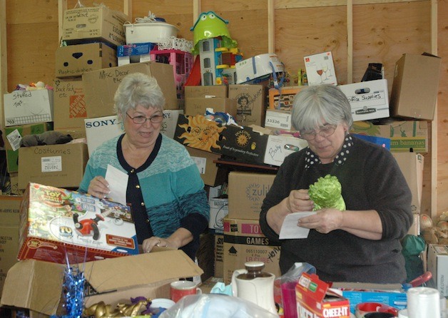 Marysville Soroptimists Carol Biegler and Marge Due sort through the goods they'll be selling at their May 10 'Junktique.'