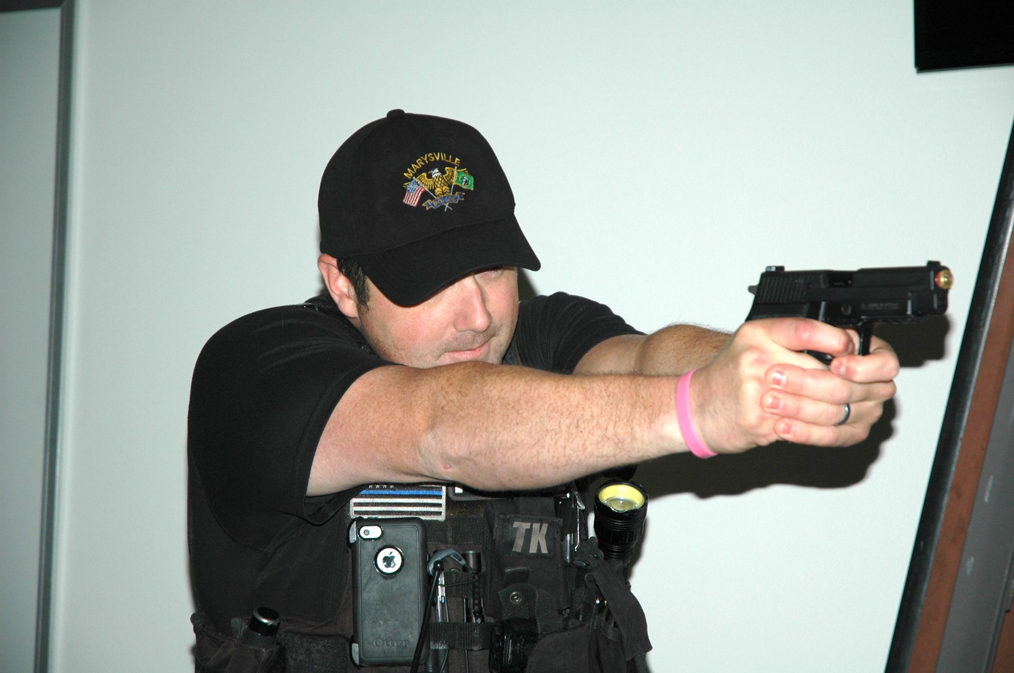 Kirk Boxleitner/Staff PhotoOfficer Mike Young seeks cover and draws his firearm during a simulated shooting at the Marysville Police Department May 11.