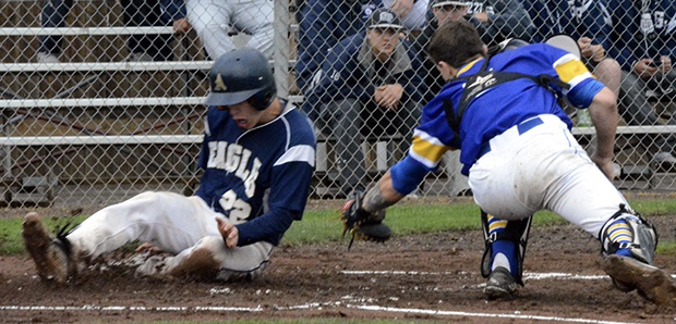 Arlington’s Gavin Rork slides home during the 3A state playoff game against Kelso.