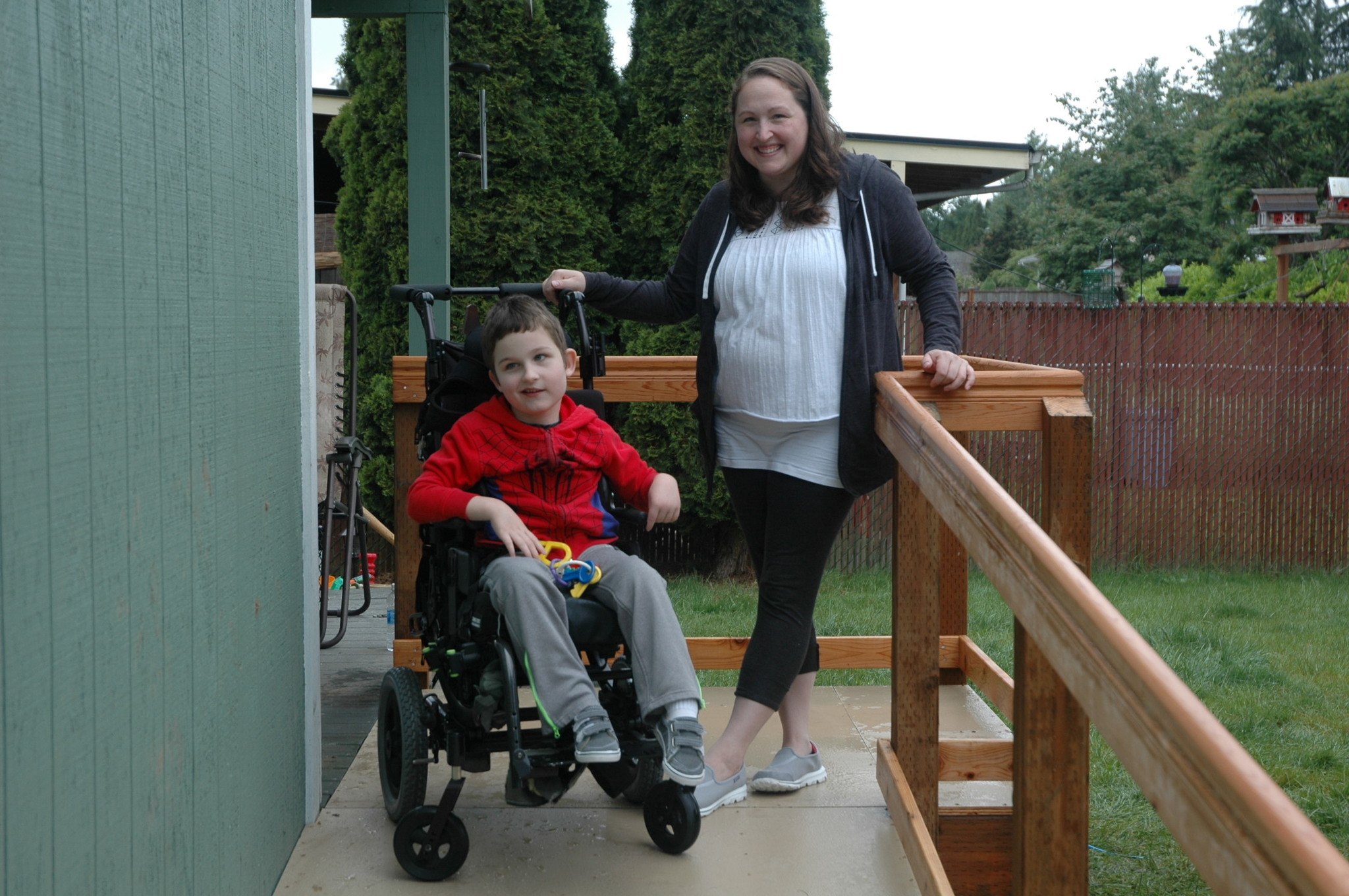 Kirk Boxleitner/Staff PhotoCarson and Angie Champine enjoy his new wheelchair ramp at their home in Marysville May 21.