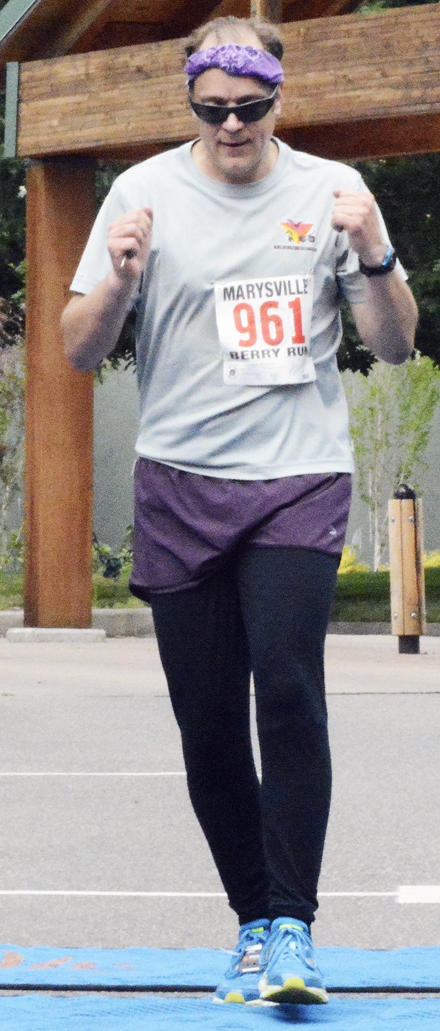 David Czjaka crosses the finish line after the annual Berry Run’s 5K race.