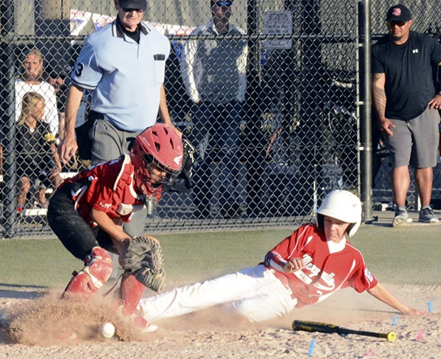 Carson Serge of the Marysville 10-and-11-year-old-team slides home.