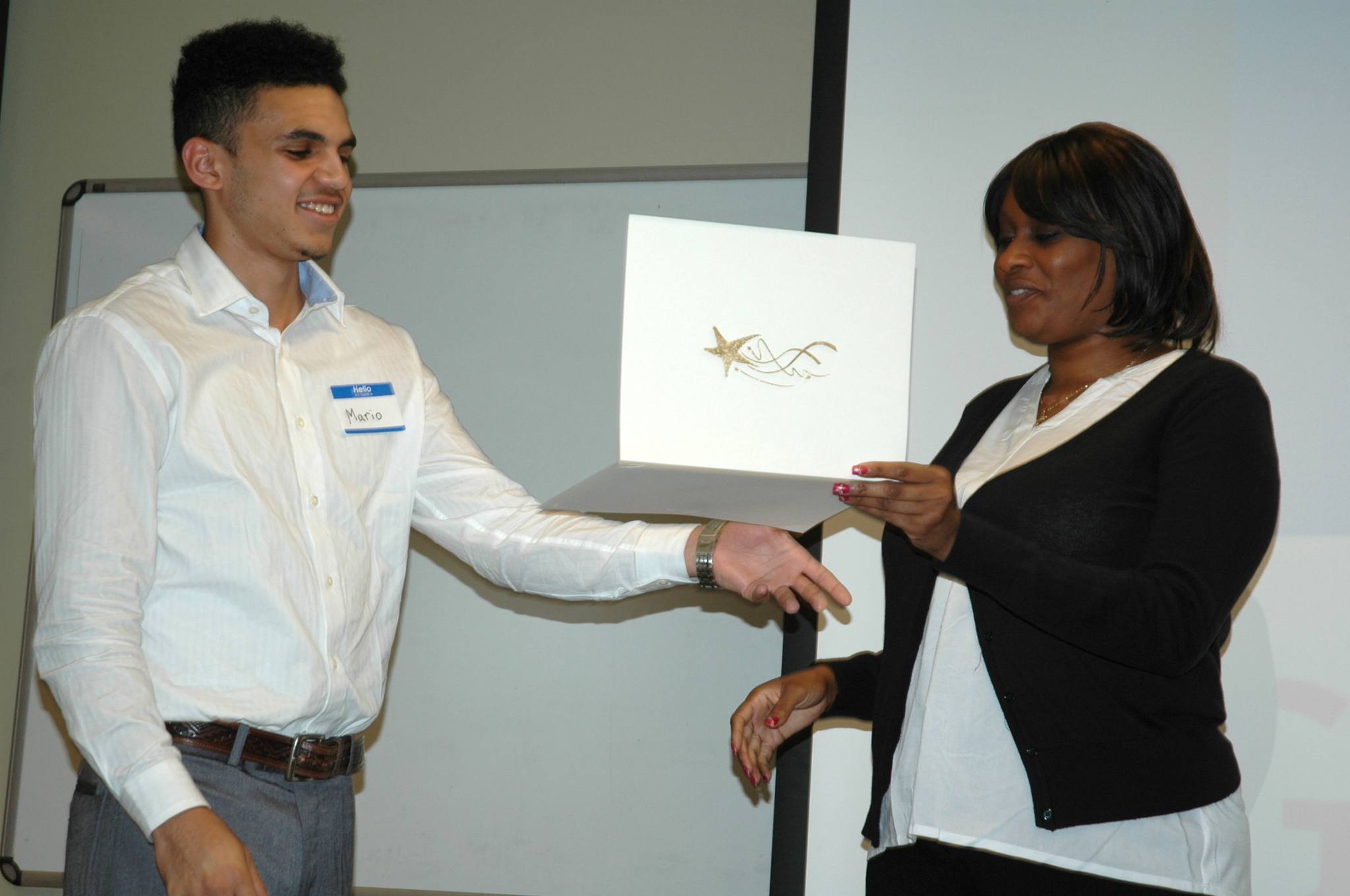 Kirk Boxleitner/Staff PhotoMarysville Goodwill Youth Aerospace Program graduate Mario Senter receives a special recognition certificate from Monique Edwards