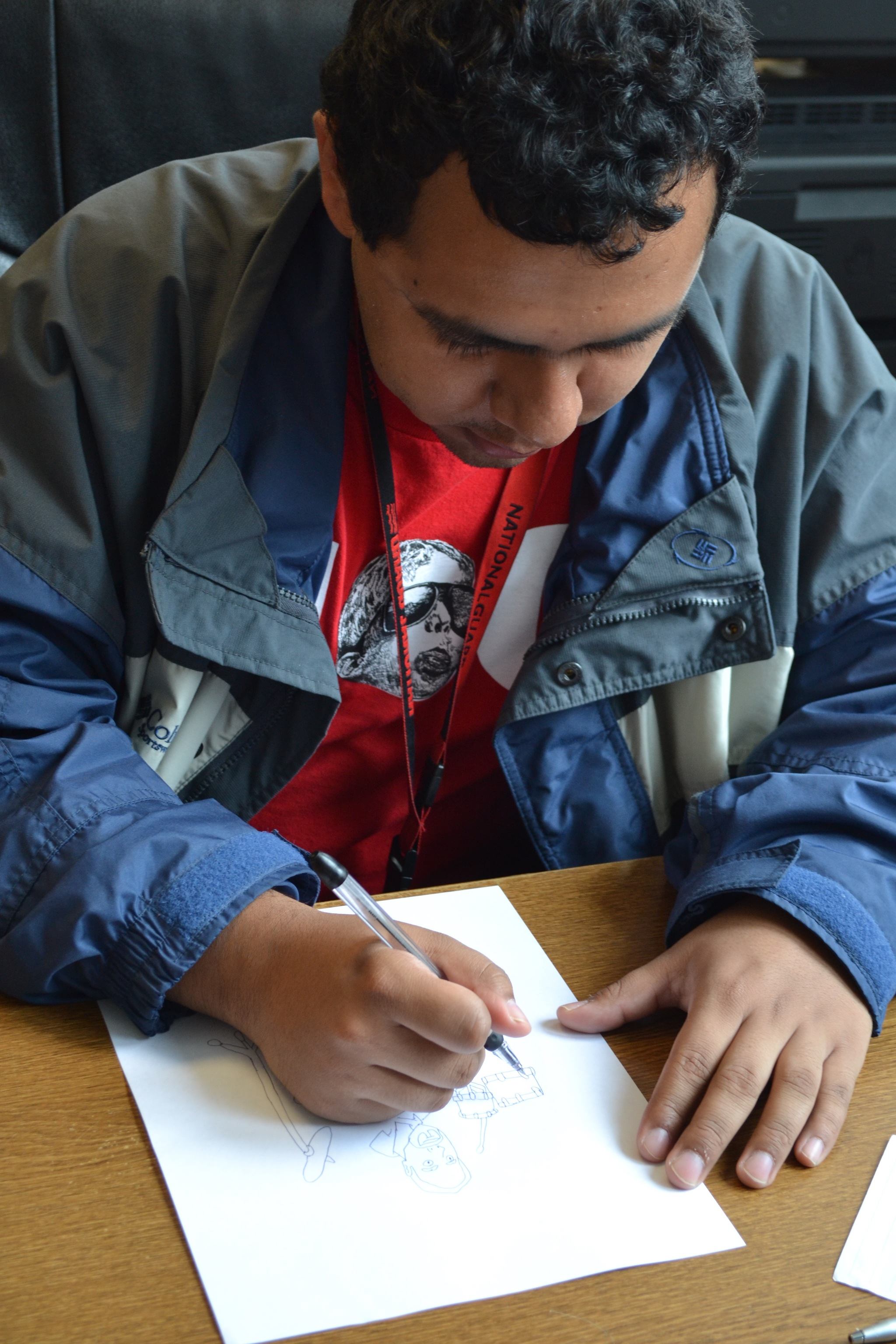 Fernando Venegas draws an editorial cartoon for The Marysville Globe-The Arlington Times newspapers.