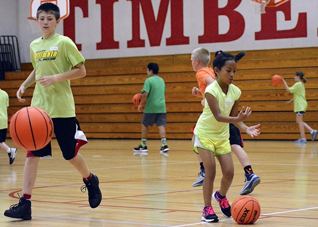 Young boys and girls are staying active this summer by participating in camps such as this basketball one.