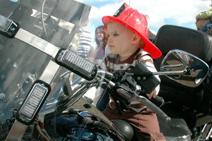 Two-year-old Aiden Zacky of Marysville sits on a police motorcycle during the “Touch a Truck” event at Totem Middle School’s Asbery Field.