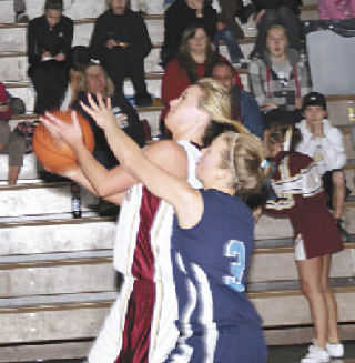 Lakewood senior Anna Work propels past defenders to make the lay-in. Work would eventually finish with a double double of 21 points and 10 rebounds.