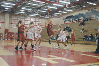 M-P junior Cali Cull puts a shot up as the Snohomish defense closes in.