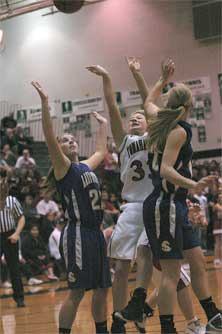 Marysville-Pilchuck sophomore Emily Enberg fights to put back an offensive rebound.