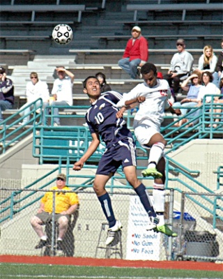 Arlington junior Juan Guadarrama fights for a ball in midfield.