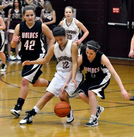 Lakewood senior Ashley Orr battles Coupeville junior guard Shelby Kulz for a loose ball near midcourt.