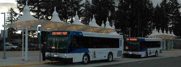 Buses pull up to the new transit center a block north of the old one